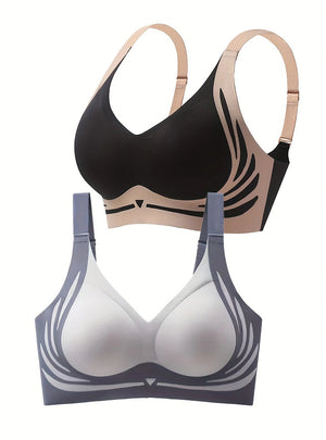 Black and beige bra on top, white and gray bra below on a white background