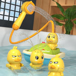 Yellow duck bath toys with a water gun and green rubber duckie in a bathtub.