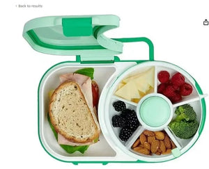 Lunch box with compartments containing a sandwich, fruits, vegetables, and nuts.