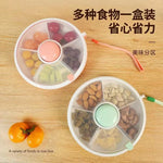 Two compartmentalized food containers with snacks on a wooden surface, featuring Chinese text.