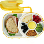 Yellow and white bento box with a sandwich, fruits, and vegetables.