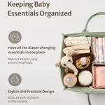 Green baby organizer with diapers, wipes, and toys on a light gray background