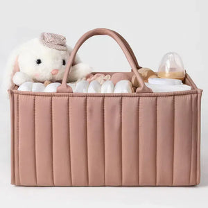 Pink baby organizer with toys and bottles on a light gray background