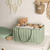 Green storage box with toys on a shelf in a child's room