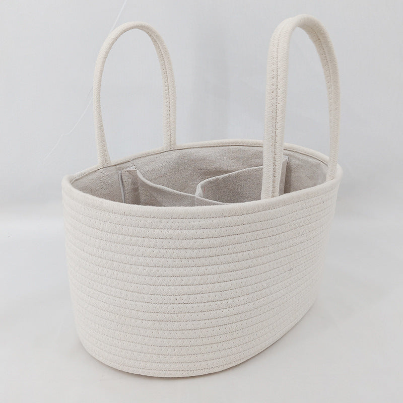 Beige woven basket with handles on a light gray background