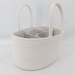 Beige woven basket with handles on a light gray background