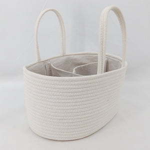 Beige woven basket with handles on a light gray background