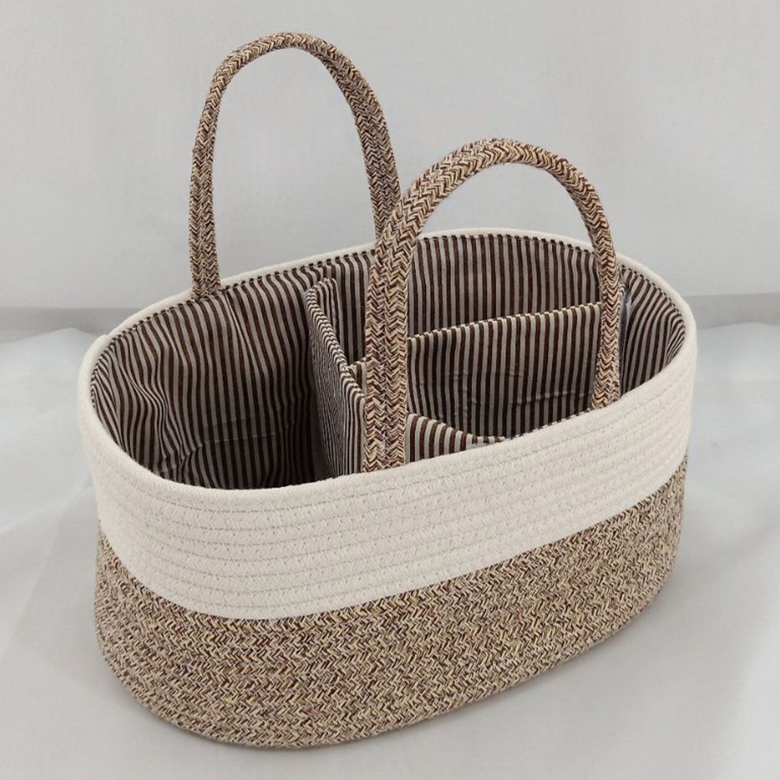 Woven basket with striped interior on a light gray background