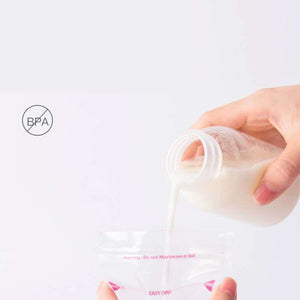 Hand holding a bottle with milk, labeled 'BPA-free', on a white background.