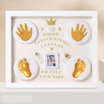 Decorative frame with gold hand and foot prints, a photo, and text on a beige background