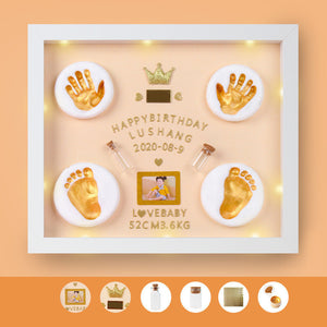 Decorative frame with gold hand and foot prints, a photo, and text on an orange background