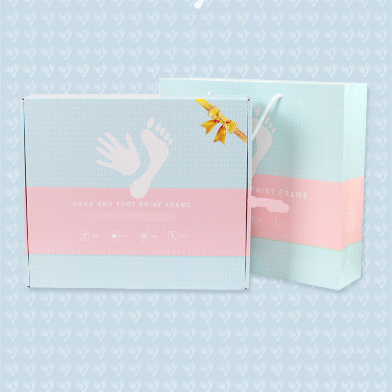 Hand and foot print frame packaging on a light blue background with white polka dots