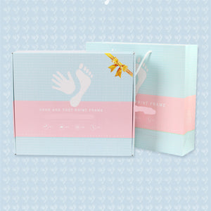 Hand and foot print frame packaging on a light blue background with white polka dots