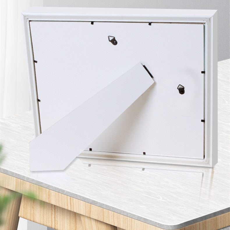 White mailbox with a white envelope on a wooden surface