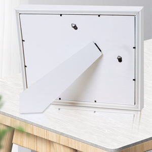 White mailbox with a white envelope on a wooden surface