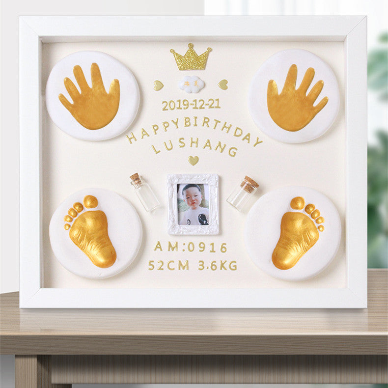 Decorative frame with gold hand and footprints, photo, and text on a white background