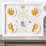 Decorative frame with gold hand and footprints, photo, and text on a white background