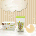 Baby care products including a box and a bag with tree graphics on a light background.