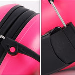 Close-up of a pink ear vover with a black strap on a white background