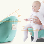 Baby in a green baby carrier with measurements indicated
