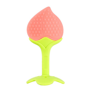 Pink and green silicone teething toy on a white background