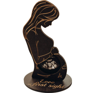 Decorative stand with silhouette of a pregnant woman and ultrasound, featuring the text 'Love at first sight'.