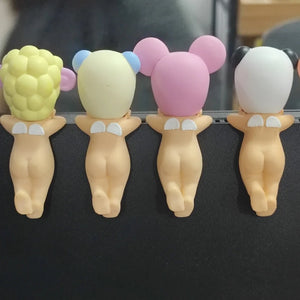 Five cartoon-style baby figurines with different colored heads on a black background