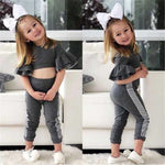 Two images of a young girl in a gray outfit with ruffled sleeves and white bows, sitting on a white couch.
