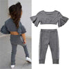 Gray ruffled top and pants set with a child wearing it on a light gray background