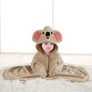 Baby wearing a beige koala hooded towel on a white surface