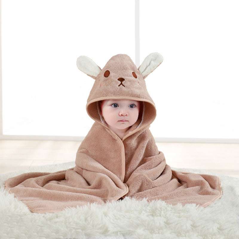 Baby wrapped in a brown hooded towel with bunny ears on a white background