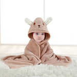 Baby wrapped in a brown hooded towel with bunny ears on a white background