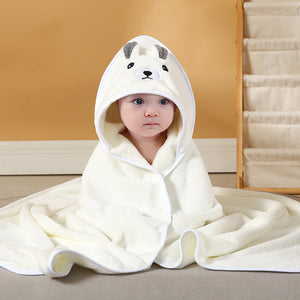 Child wearing a white hooded towel with a dog face design on a beige background