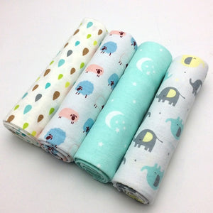 Four rolls of fabric with animal patterns on a white background