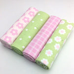 Four rolls of fabric with different patterns on a white background