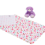 Floral-patterned blanket with a purple teddy bear on a white background