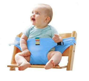 Baby sitting on a wooden stool with a blue baby seat