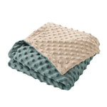 Stack of two textured blankets, one beige and one blue, on a white background