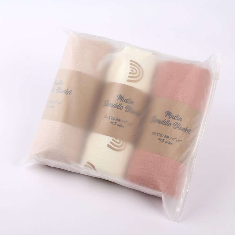 Set of three baby blankets in a clear packaging on a white background