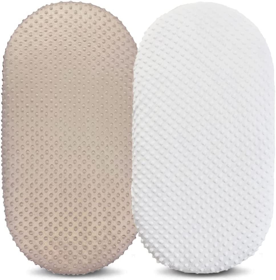 Two textured pillows, one beige and one white, on a white background