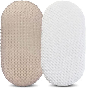 Two textured pillows, one beige and one white, on a white background