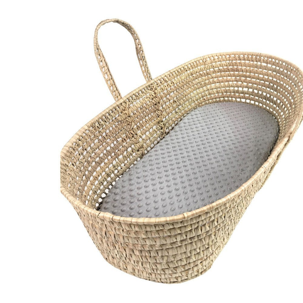Woven baby crib with gray interior on a white background