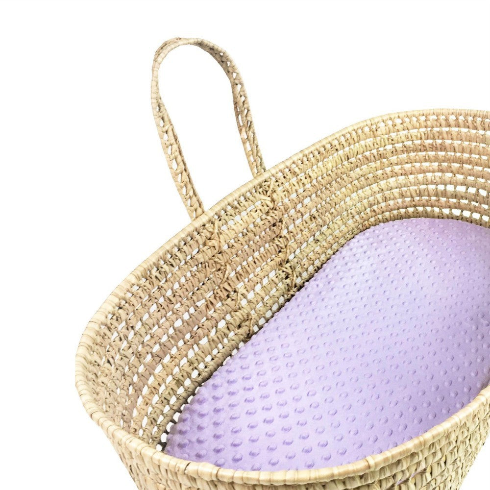 Woven basket with a purple cushion on a white background