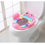 Colorful children's toilet seat on a toilet in a bathroom setting