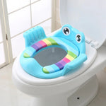 Children's toilet seat with rainbow design and frog face on a toilet