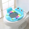 Children's toilet seat with rainbow design and frog face on a toilet