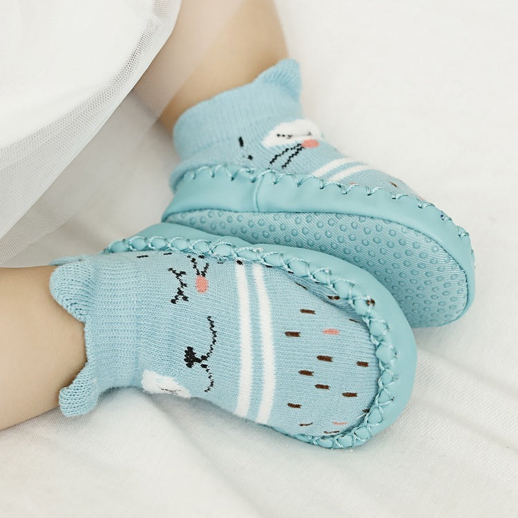 Light blue baby socks with cartoon designs on a white background