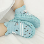 Light blue baby socks with cartoon designs on a white background