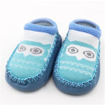 Pair of blue baby socks with owl design on a white background
