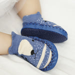 Blue baby socks with a bear design on a white background